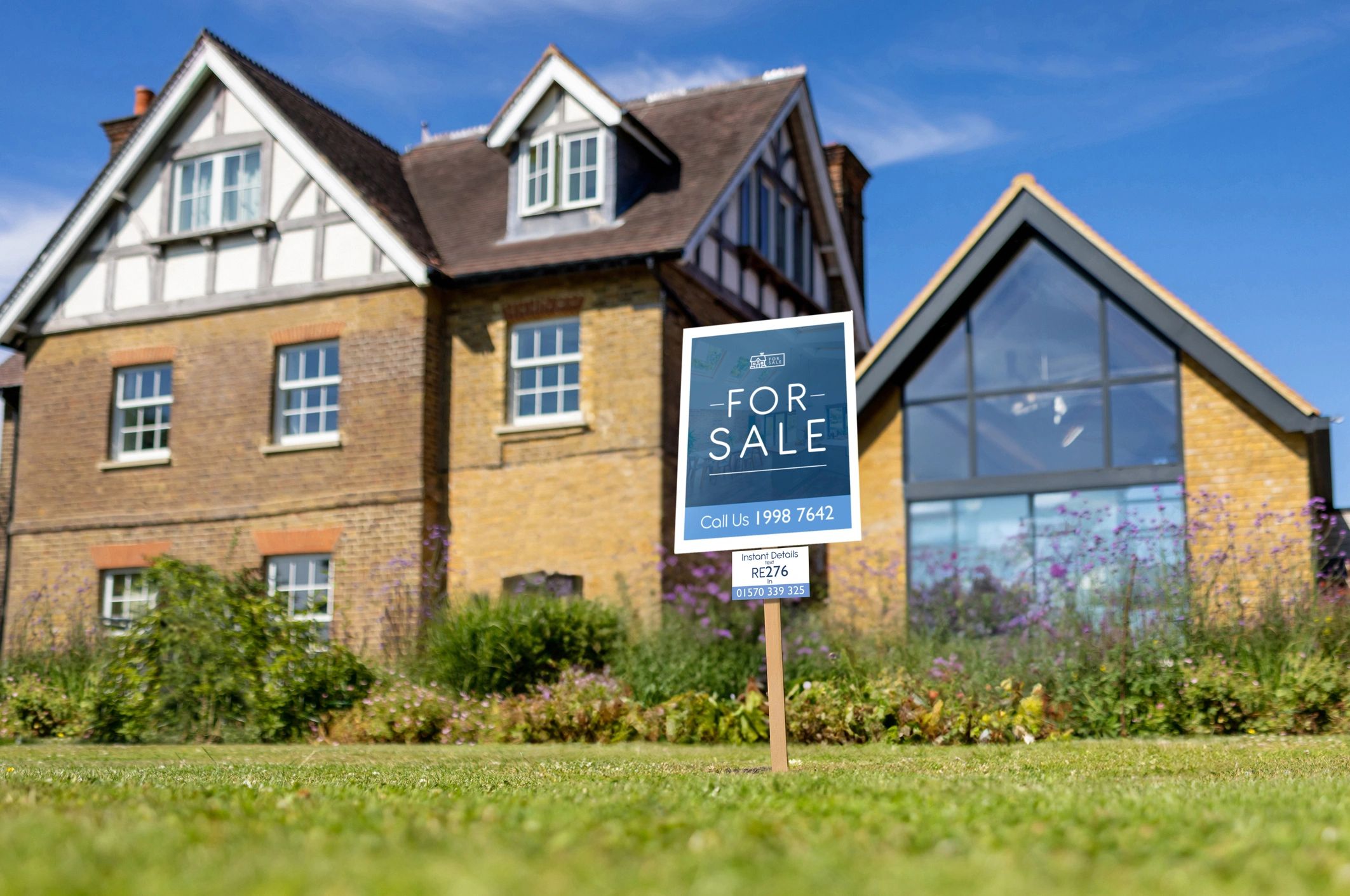 House with a real estate sign in the front yard